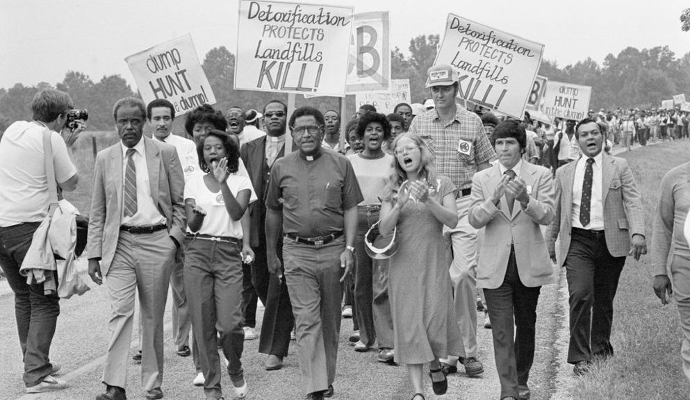 Black and white photo of environmentalists marching in the 1960s
