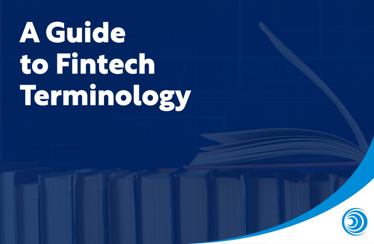 Stack of books with one open book and text reading “A Guide to Fintech Terminology.”